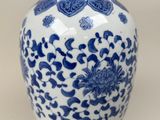 a blue and white vase sitting on a table