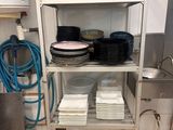 many plates and bowls stacked on a shelf in the kitchen