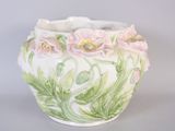 a white vase with pink and green flowers on it