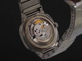 a close up of a watch on a metal bracelet