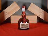 a bottle of liquor sitting on a table next to wooden blocks