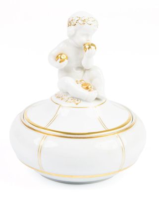 figurine en porcelaine représentant un singe assis sur une boîte blanche