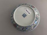 a blue and white vase with a tag on it