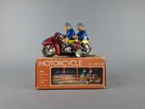 figurines of two people riding on a motorcycle on a box