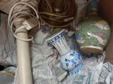 a box full of assorted items that include a lamp, vases, and other items