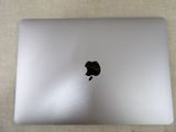 a white laptop with a black apple logo on it