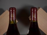 two bottles of wine sitting next to each other on a table