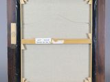 an old picture frame with a piece of paper taped to it