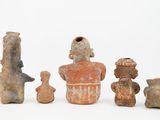 several pieces of pottery sitting on top of a white surface