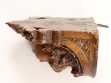 an antique wooden shelf with carvings on it against a white background