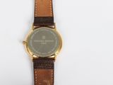 an image of a close up of a wrist watch on a white surface