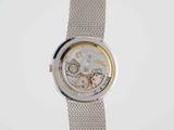 a close up of a watch on a white surface