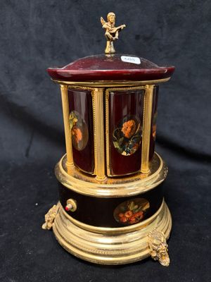 a small decorative box with an angel on top of it