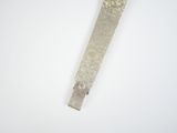 a silver tie that is on a white surface
