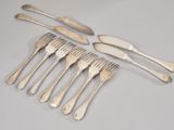 six forks and a knife on a table with a white background