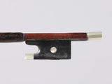 a violin bow with a wooden handle on a white surface