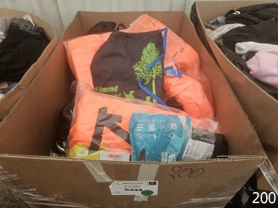 a cardboard box full of clothes and a bag full of clothes