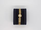 a close up of a watch sitting on top of a velvet case