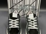 black and white sneakers with white laces and a box of black and white shoes