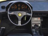 dashboard of a black sports car with a steering wheel and gauges