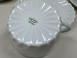a white bowl with a lid that is sitting on a table