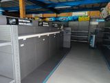 many empty shelves in a store with signs on them