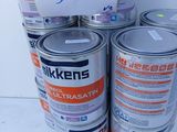 several cans of paint are stacked on top of each other