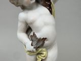 a figurine of a boy holding a leaf