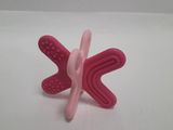 a pink butterfly shaped object on a white surface