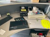 a computer desk with a keyboard, mouse, and other items on it