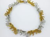 a gold and silver necklace with elephants on it