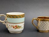 two coffee cups sitting next to each other on a table