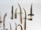 many different types of knives displayed on a white surface