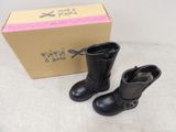 a box with a pair of black boots next to a pair of black boots