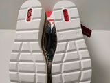 the soles of a pair of white shoes with red soles