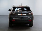 the back end of a grey suv parked in a room