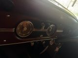 a dashboard of a vintage car with a clock on it