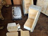 several pieces of wood are sitting on a table next to a picture frame