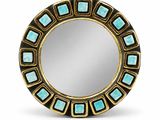 a close up of a round mirror with a gold frame