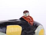 a figurine of a man sitting in a toy car