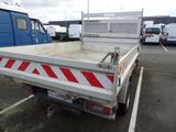 a white truck with red and white stripes parked in a parking lot