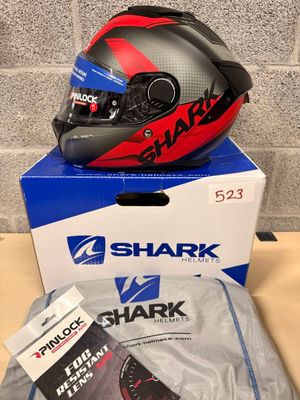 a box with a helmet on it next to a pair of shoes