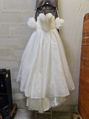 a dress hanging on a mannequin in the corner of a room