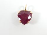 a close up of a heart shaped ruby stone pendant on a white background