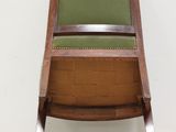 an image of a wooden chair with a green seat and back