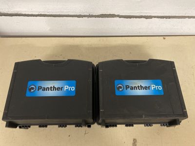 two black plastic boxes with blue and white logos on them