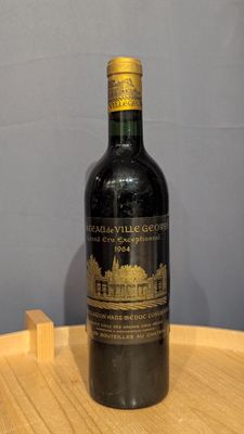a bottle of wine that is sitting on a wooden table