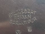 an image of a silver plate with writing on the side of it
