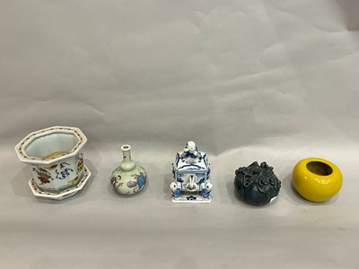 five small vases and a small vase on a white surface