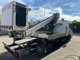 a white truck with a crane attached to it ' s back